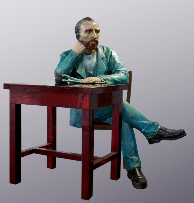 Sculpture of a man sitting at a table